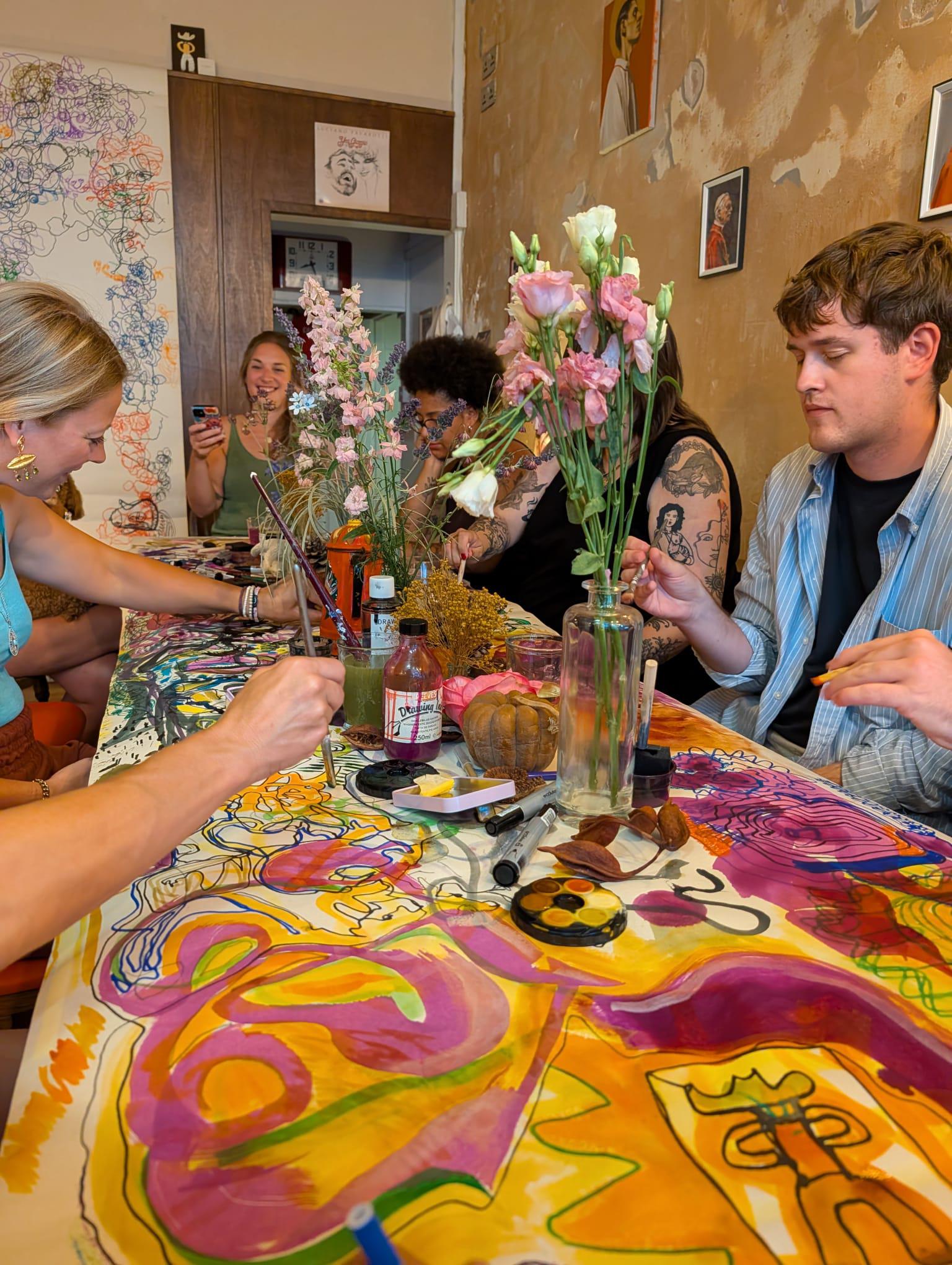Guests drawing together across a flower-filled table